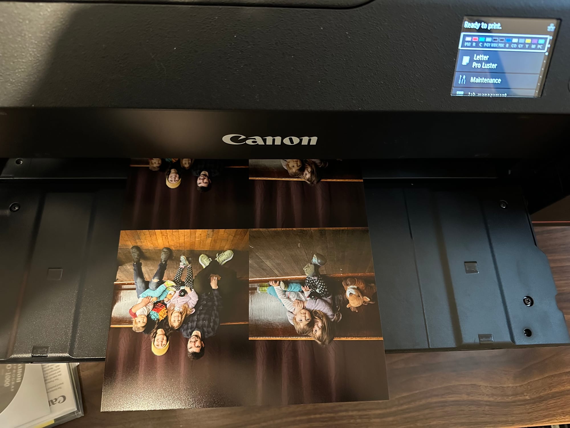 A photo printer is printing a grid of family portraits.