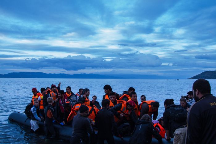 Refugees as they arrive on the beach, having crossed the Aegean Sea in rubber rafts.